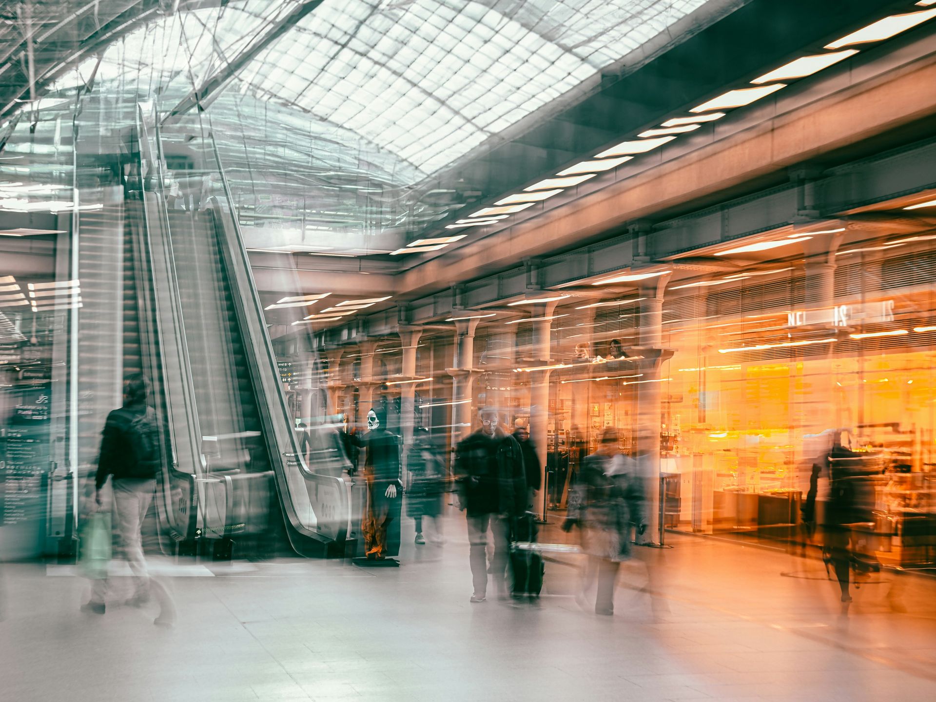 Blurred background of people shopping in a mall, representing the many satisfied customers who trust Angoer for quality and service.
